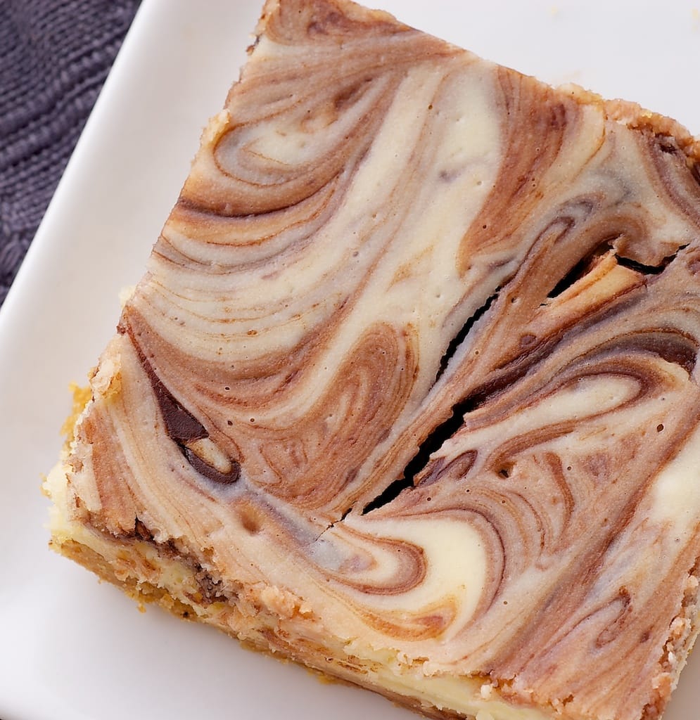 Nutella Swirl Cheesecake Bars feature a swirl of that favorite chocolate-hazelnut spread in sweet, rich cheesecake bars! - Bake or Break