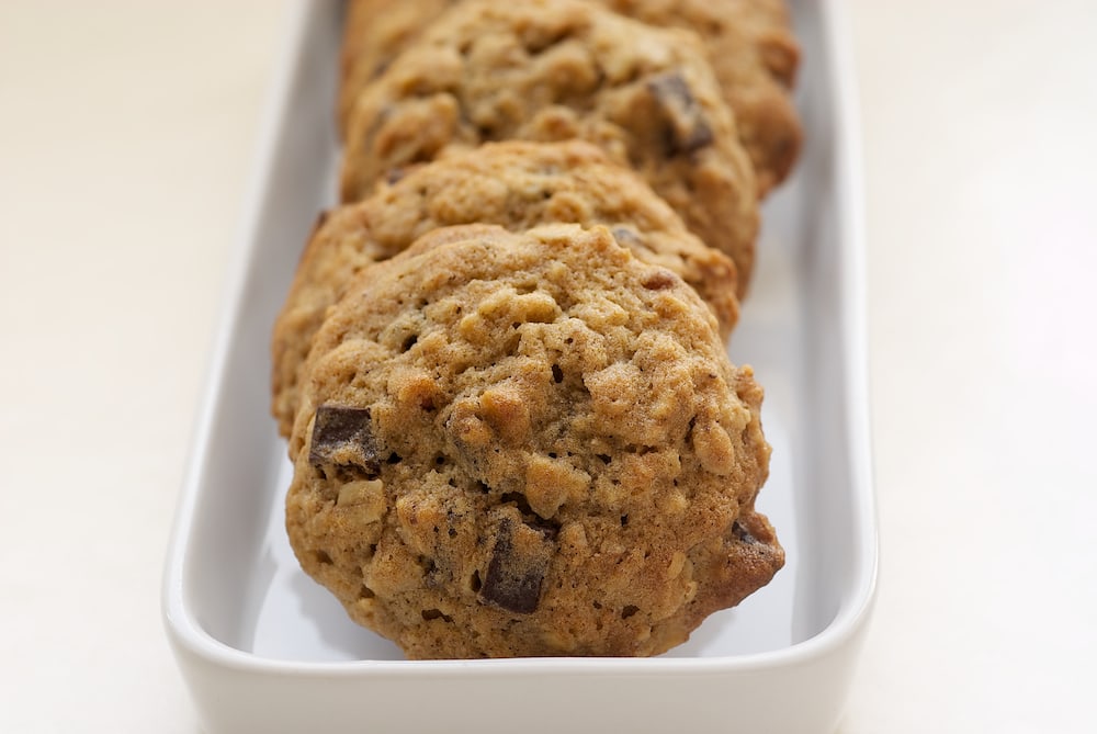 Banana Pecan Chocolate Chunk Cookies take chocolate chip cookies and amp them up with bananas, oats, and nuts. Delicious! - Bake or Break