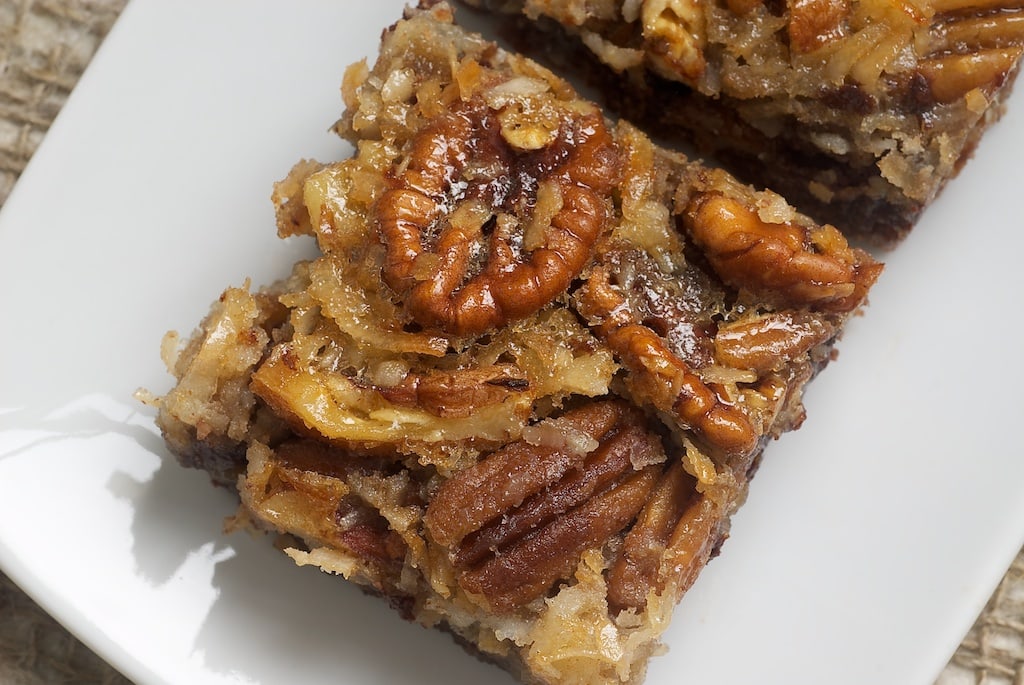 German Chocolate Pecan Pie Bars are a wonderfully delicious combination of chocolate crust, more chocolate, coconut, and pecans. A great crowd pleaser!