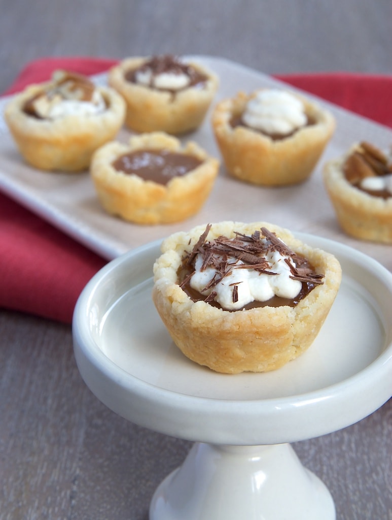 Mini Caramel Tarts combine a cream cheese crust with a rich caramel filling that can be topped with whipped cream, salt, chocolate, or your favorite topping. - Bake or Break
