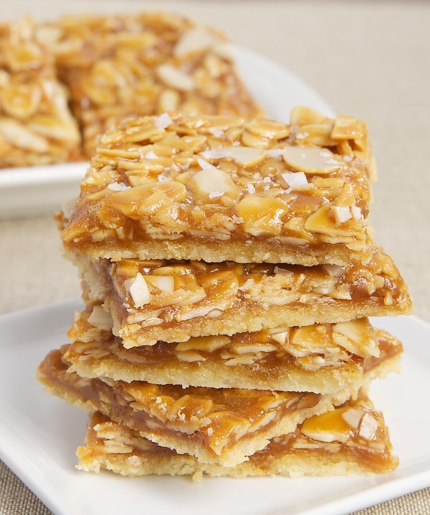 Salted Caramel Almond Bars start with a buttery crust, followed by caramel, almonds, and a sprinkling of salt. A sweet and salty favorite! - Bake or Break